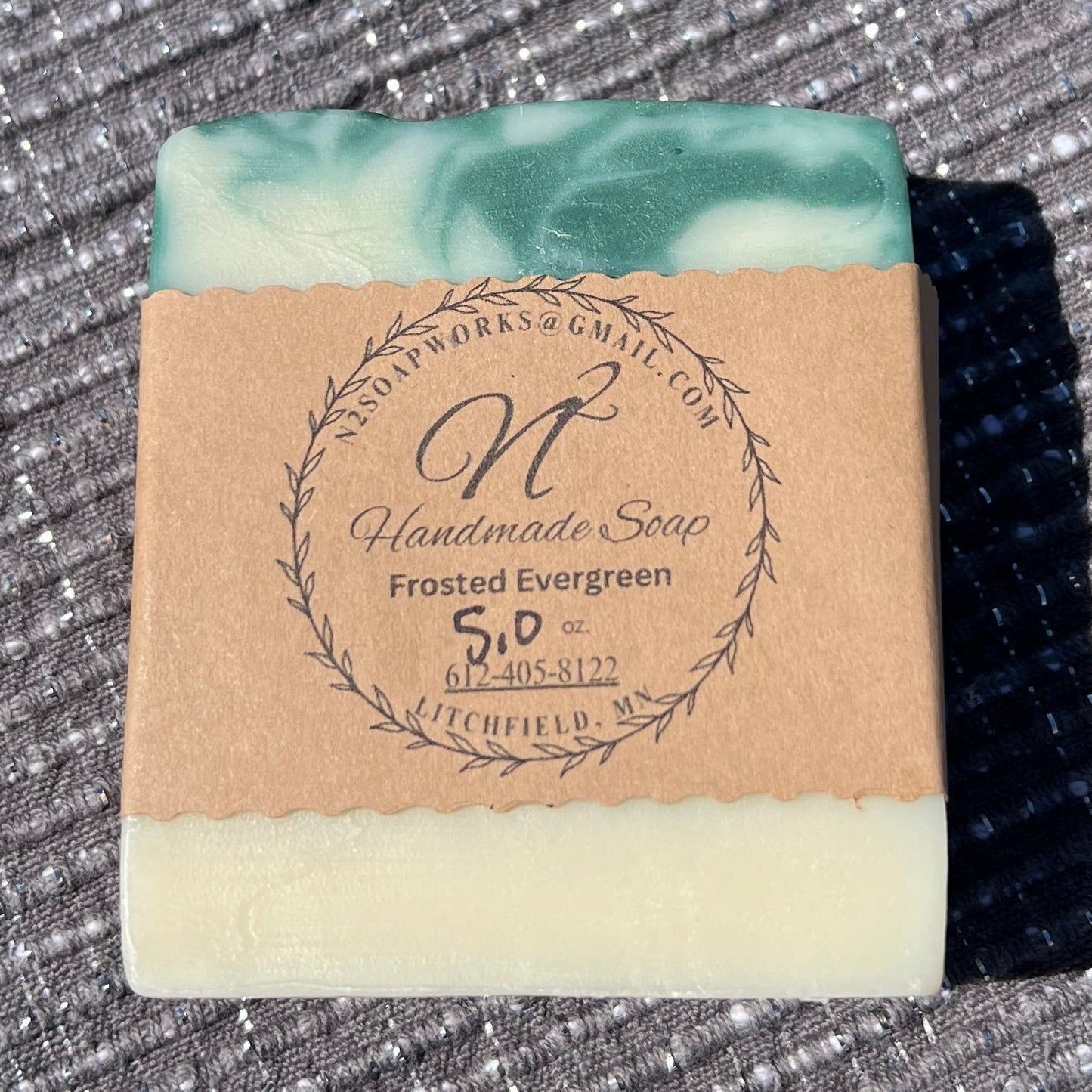 Bar of soap with a label on a textured surface