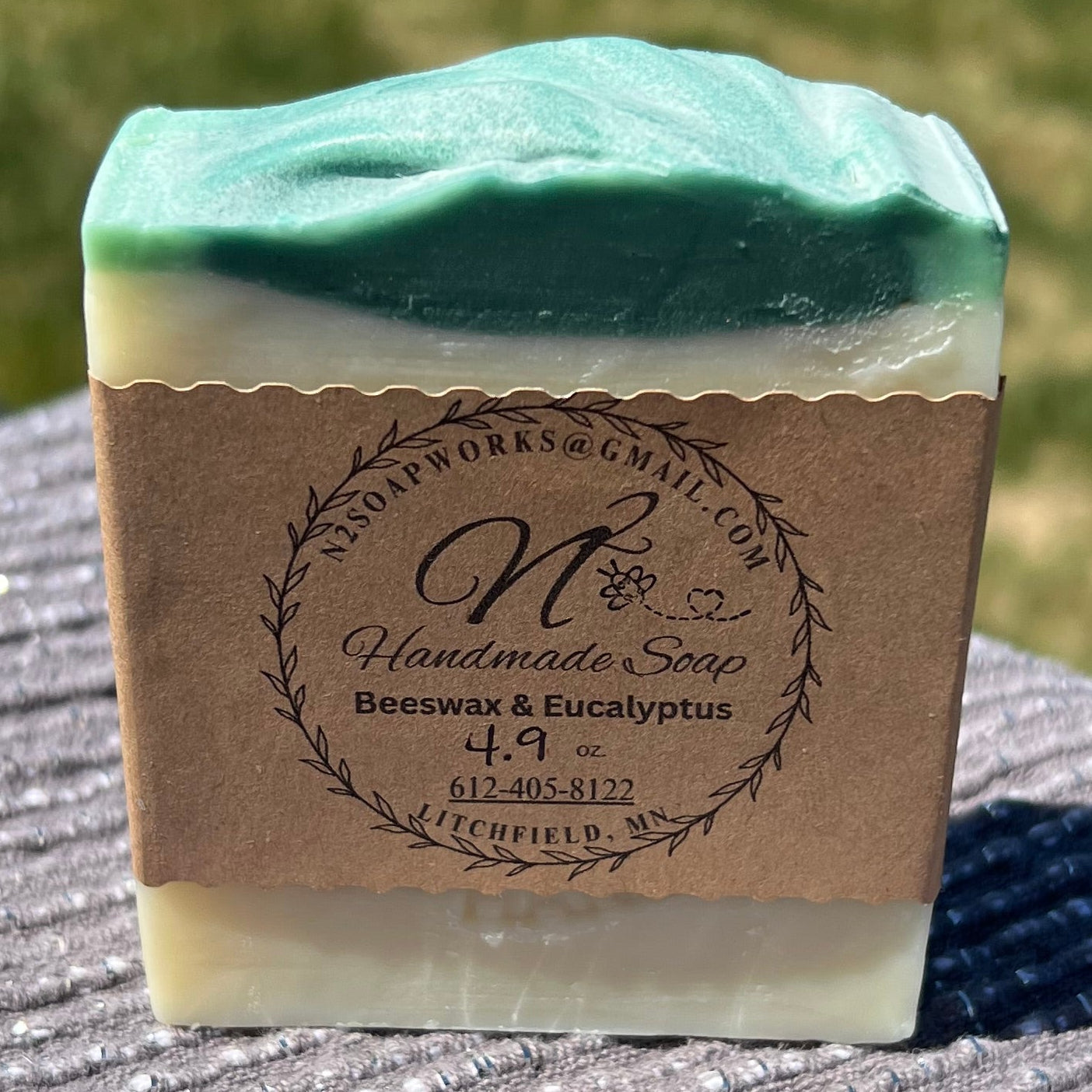 image of a bar of soap with green top, white body and brown paper label