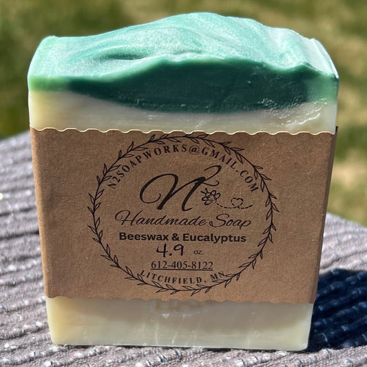 image of a bar of soap with green top, white body and brown paper label