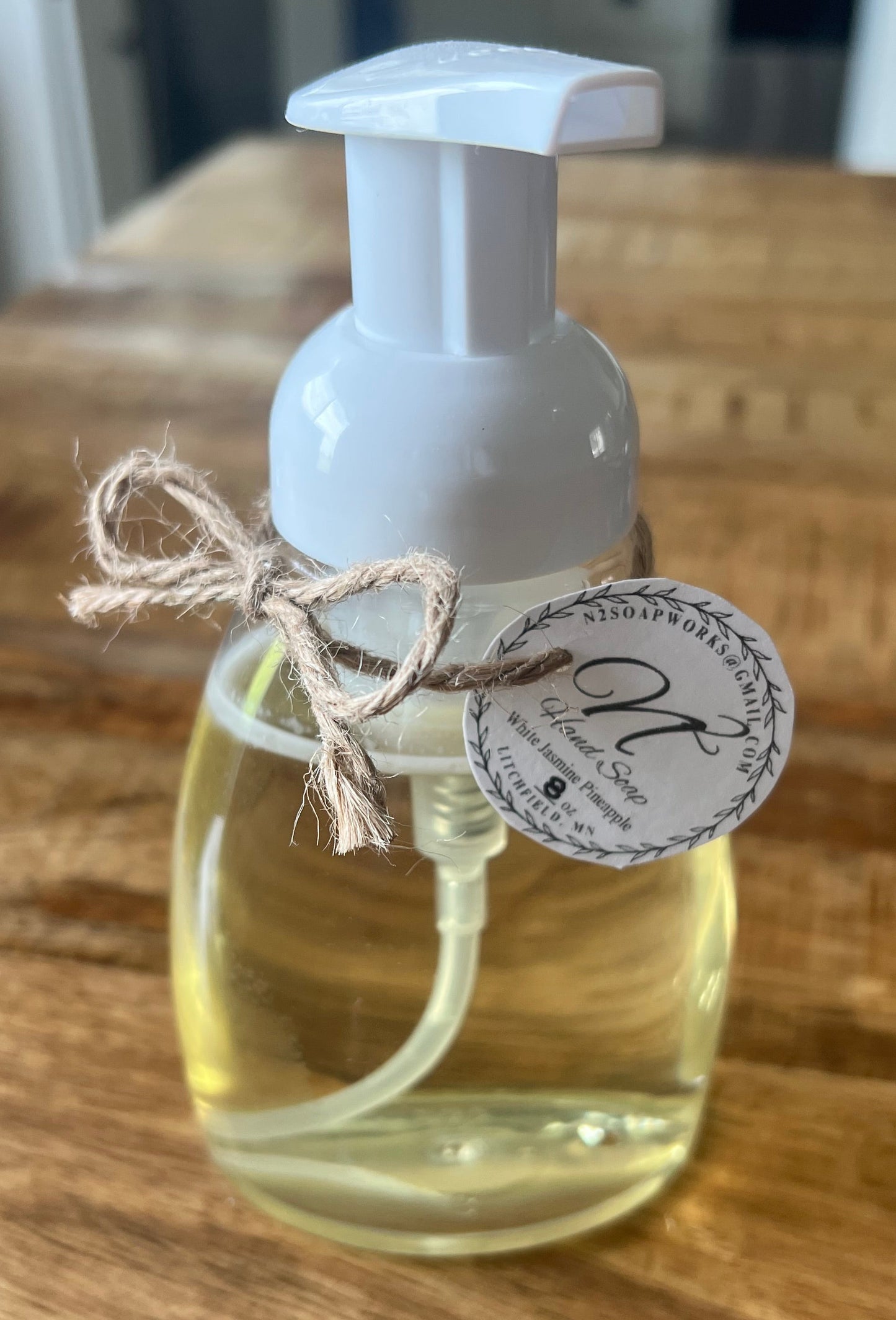 Clear bottle with white cap on a wooden surface