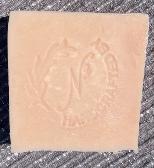 light colored bar of soap with embossed logo